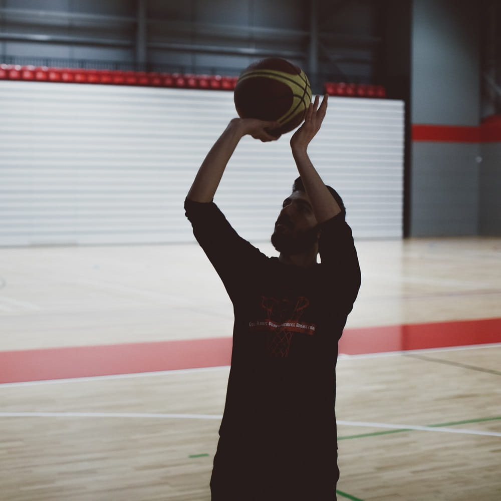 Silhouette of a man about to throw a basketball