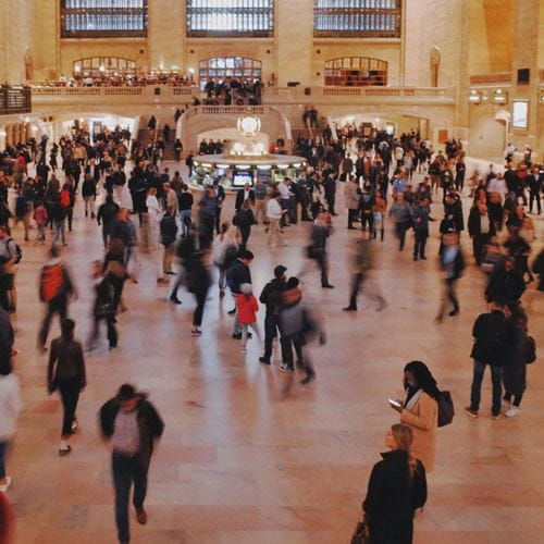 A large group of people in a building by Angie Gao