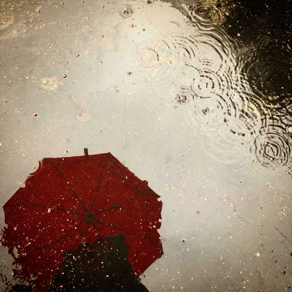 Reflection of red umbrella in the rain