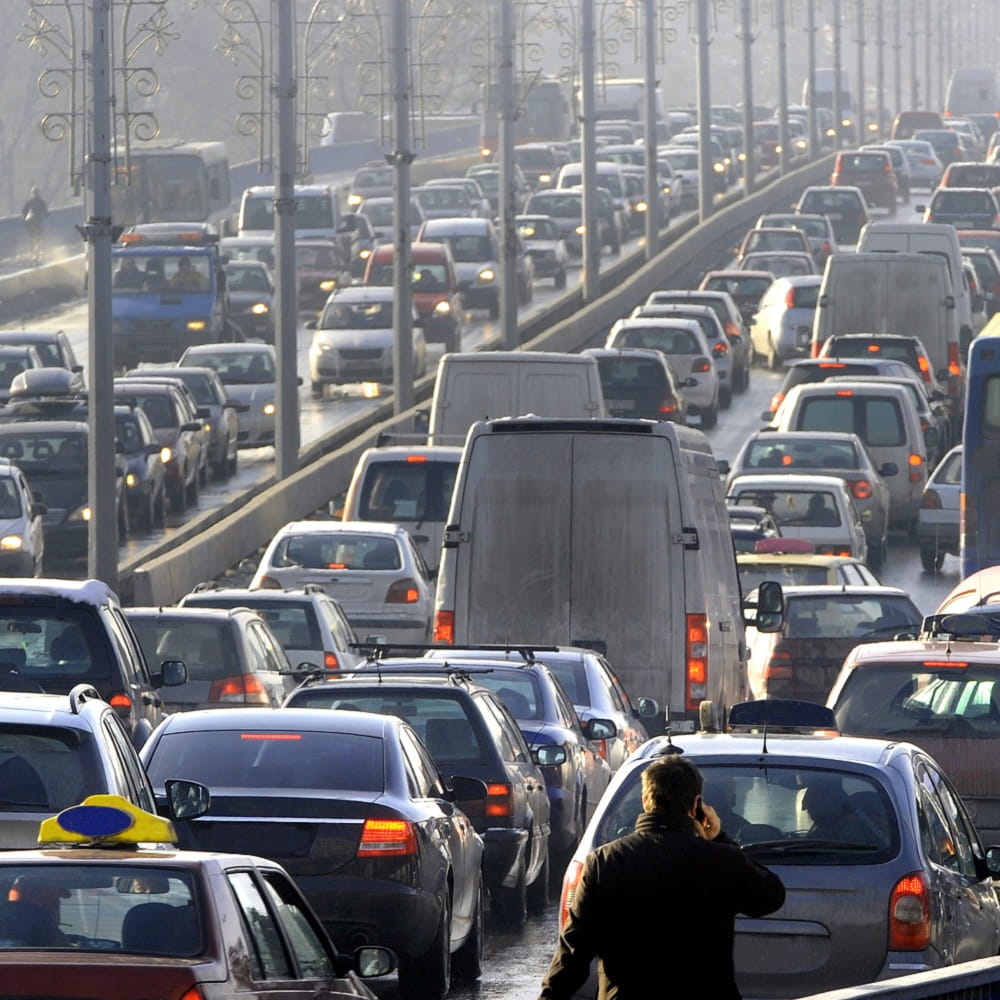 Lots of cars in a traffic jam on a bridge