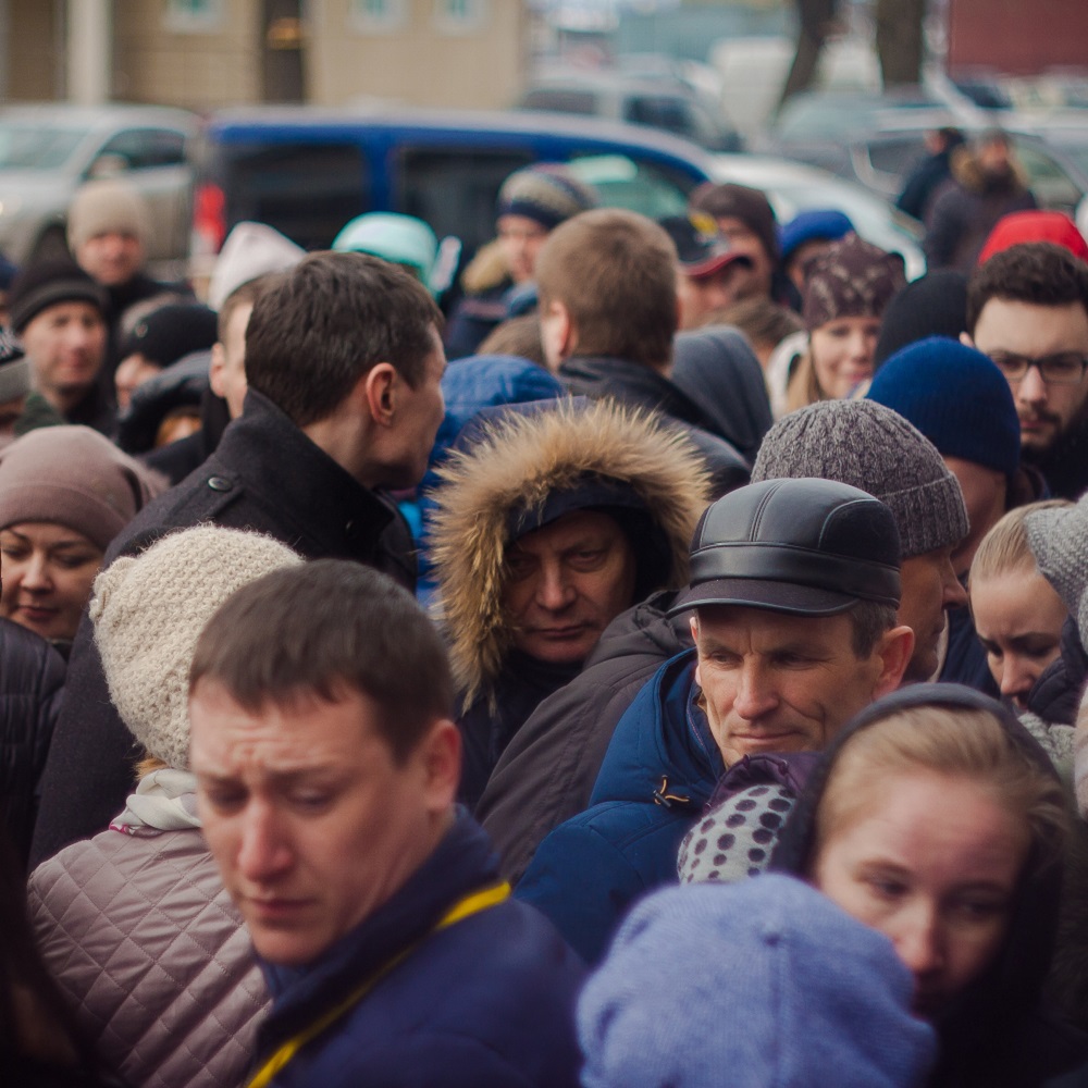 People in a crowd looking sad