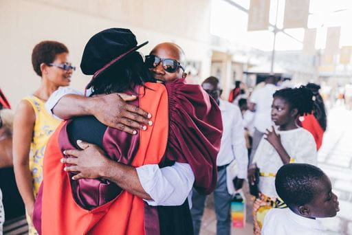 Family hugging at graduation
