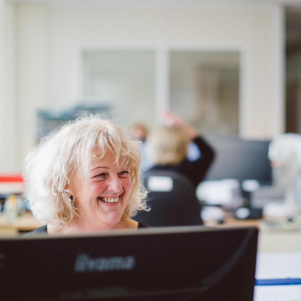 Student-facing support officer behind a computer