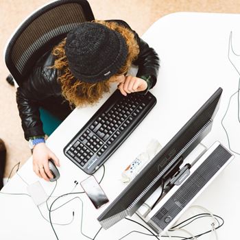Student working on computer in library
