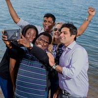 Students taking a selfie on the beach