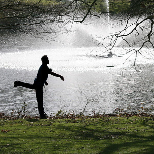 Disc golf player taking a shot
