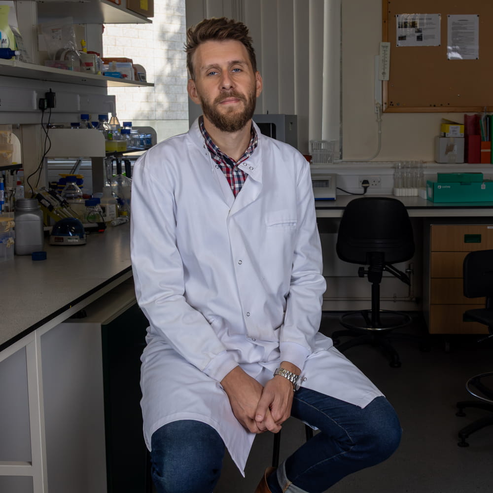 A headshot Dr John Ferguson in his laboratory