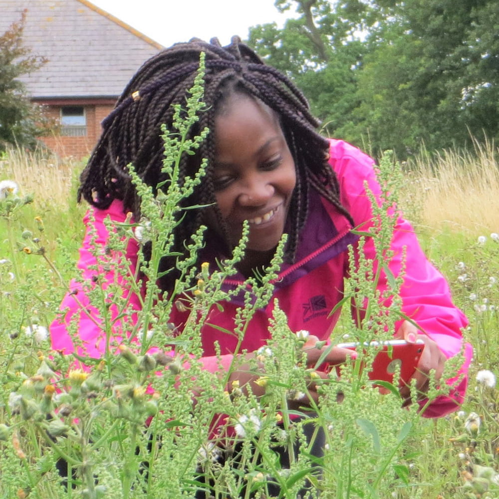 Woman taking a photo of a flower