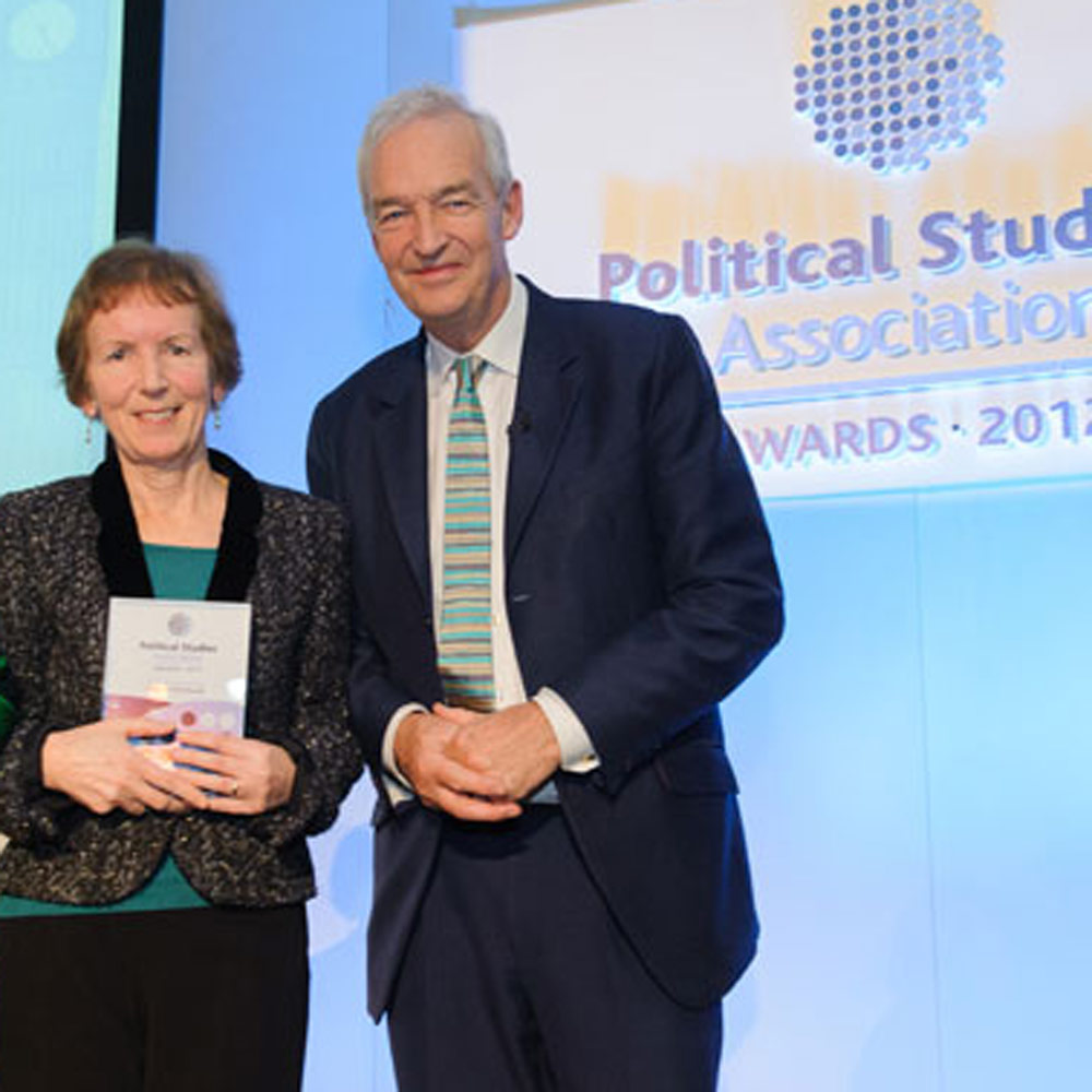 Professor Vicky Randall receives award from Jon Snow