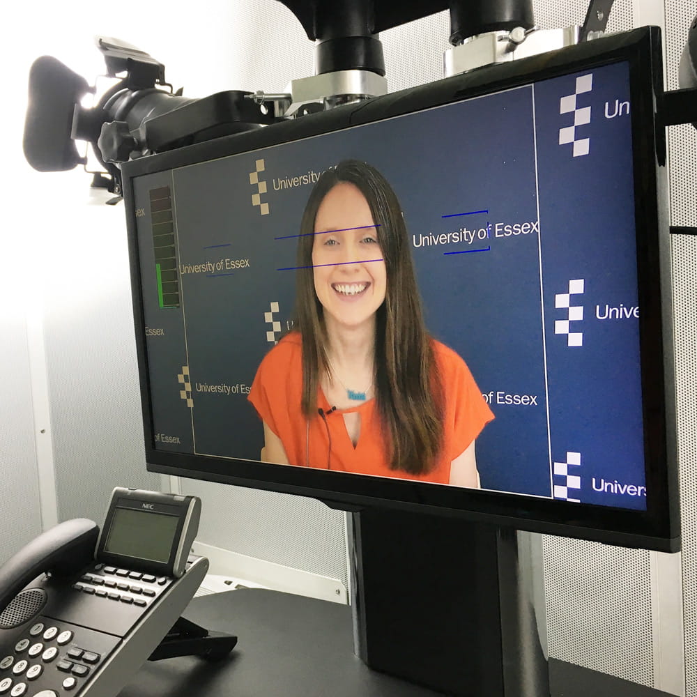 TV screen showing a woman giving a TV interview