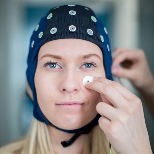 Woman with a sensor net on her head for an experiment
