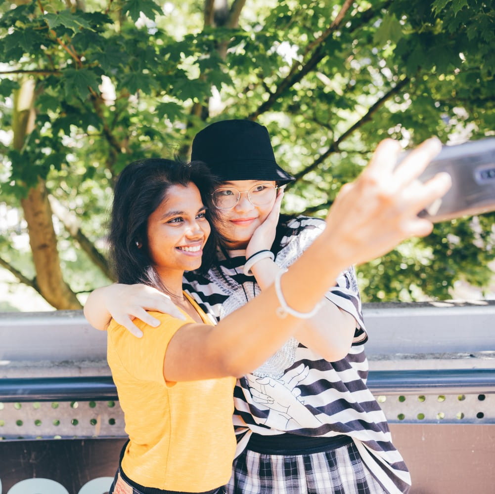 two girls taking a selfie with a mobile phone