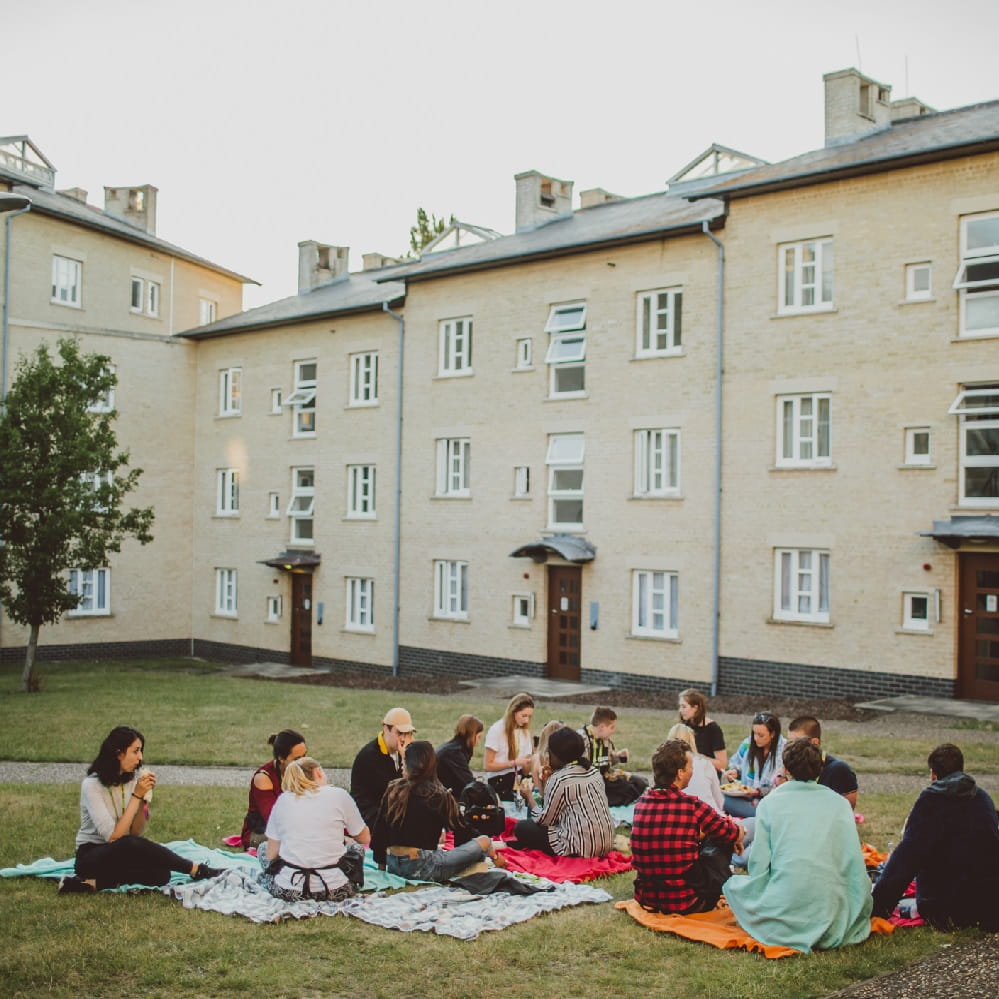 Summer school students sitting outside sharing a meal 