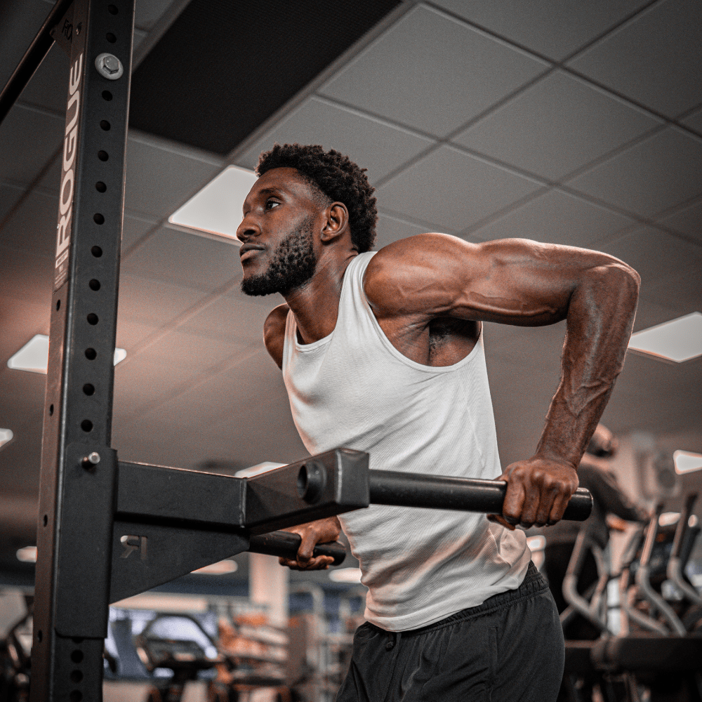 Student lifting themselves up in the gym