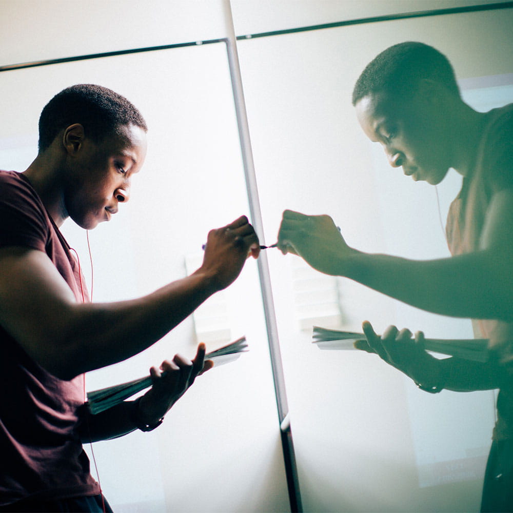 Male student using interactive whiteboard