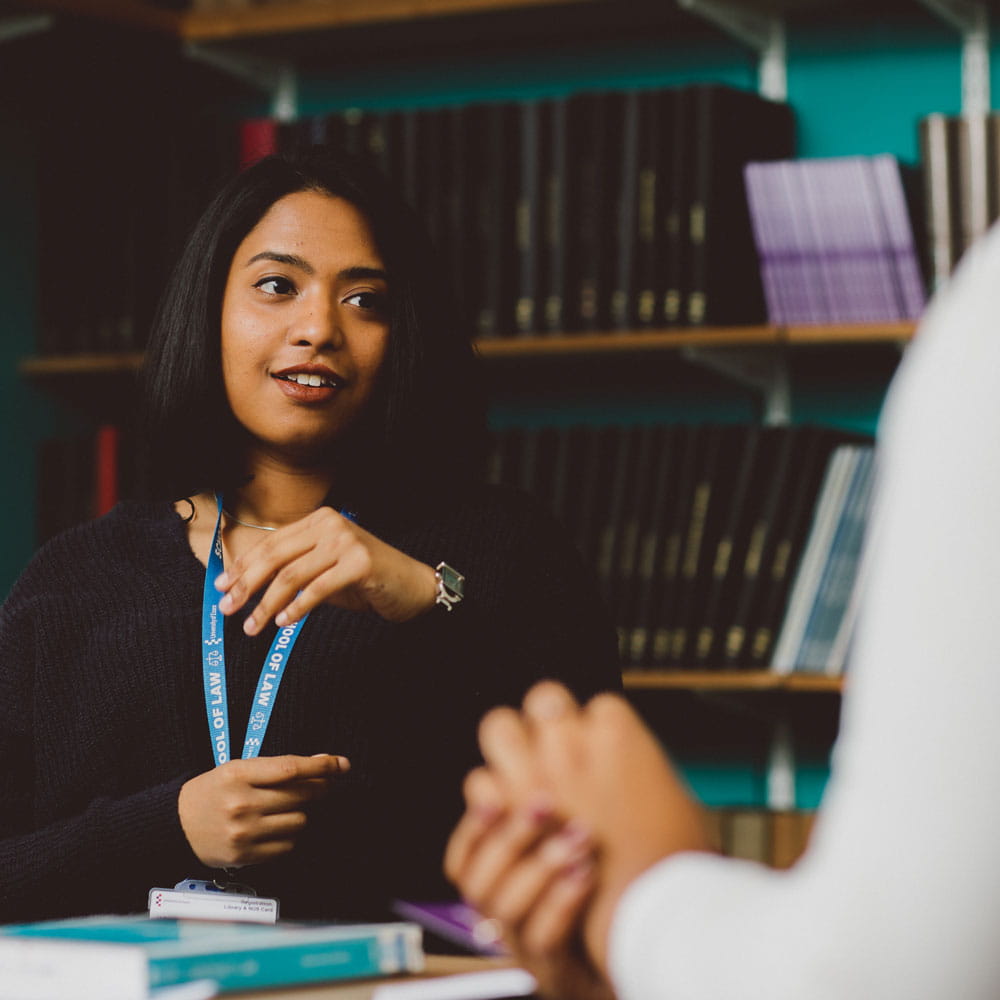 Student discussing in library