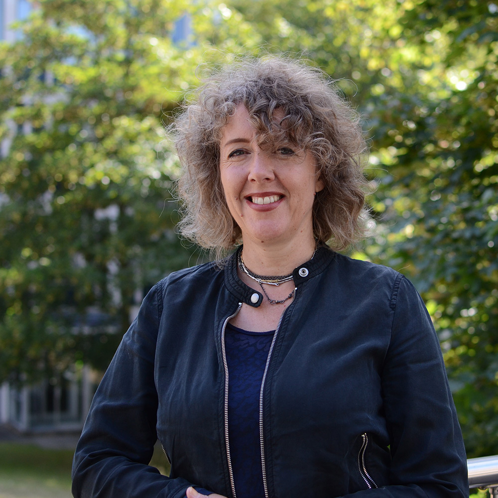 Jessie Mallinson standing on a bridge near Square 2, Colchester Campus