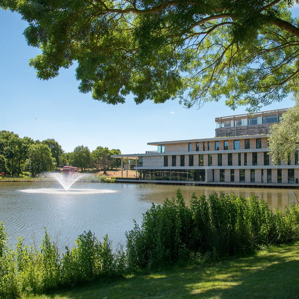 The lake at Colchester campus on a sunny day.