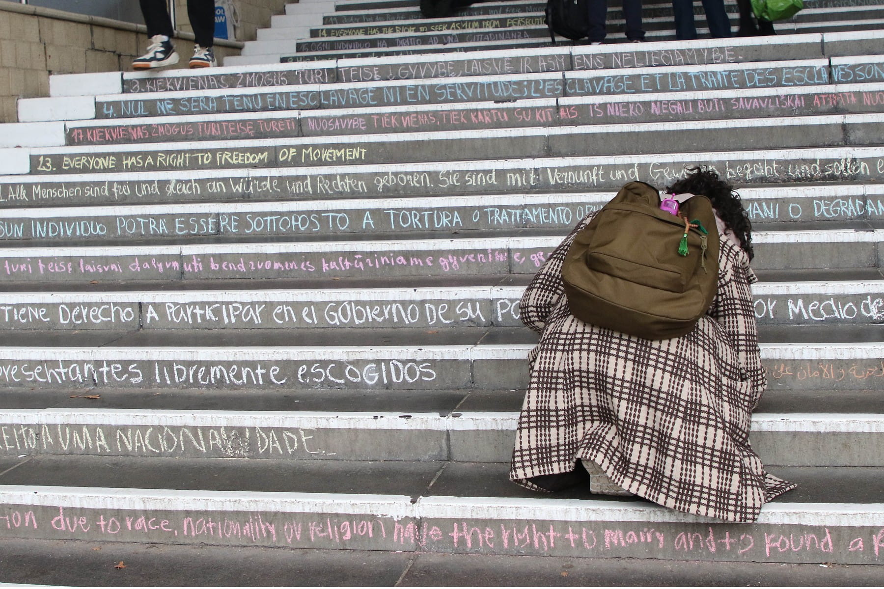A student chalking the steps on the Colchester campus