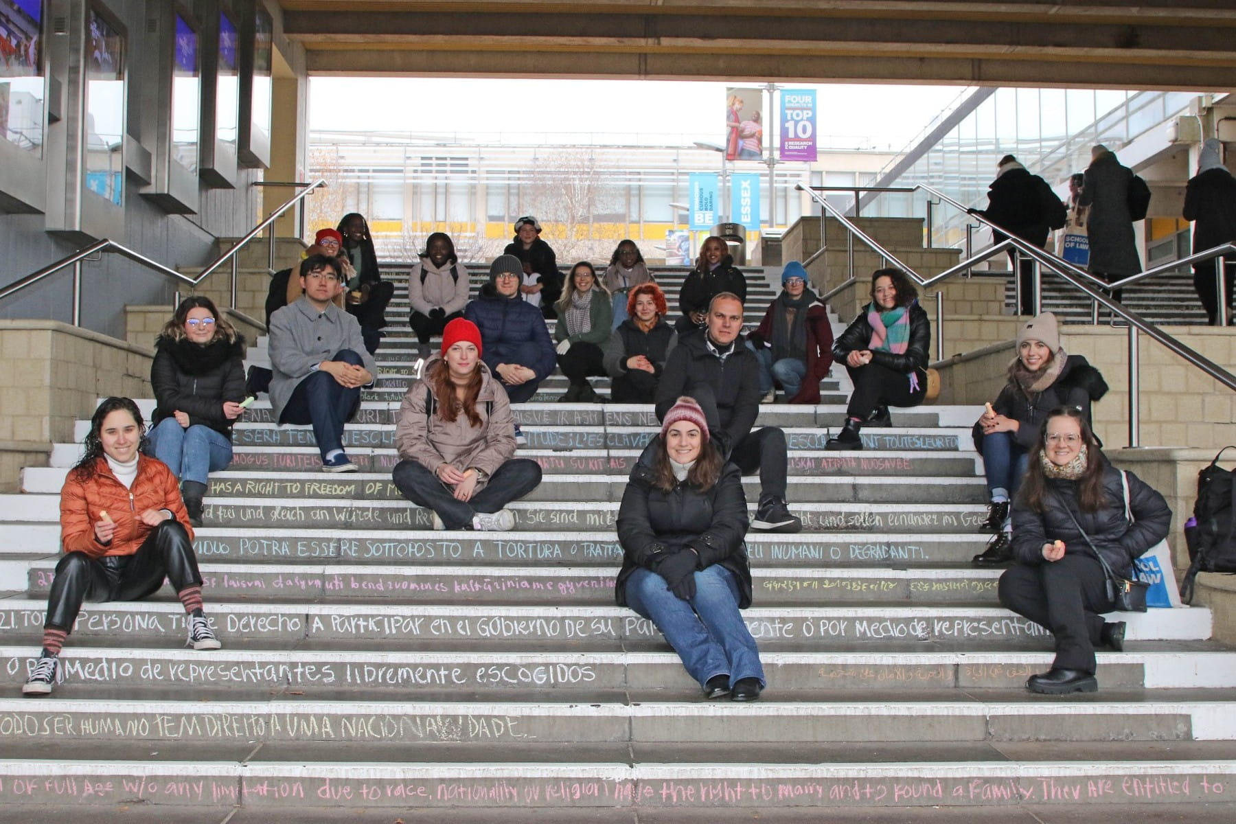 Members of the Human Rights Society sat on the newly chalked steps