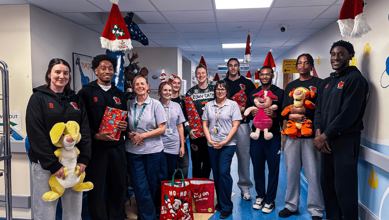 Essex Rebels players pose for a photo with hospital staff