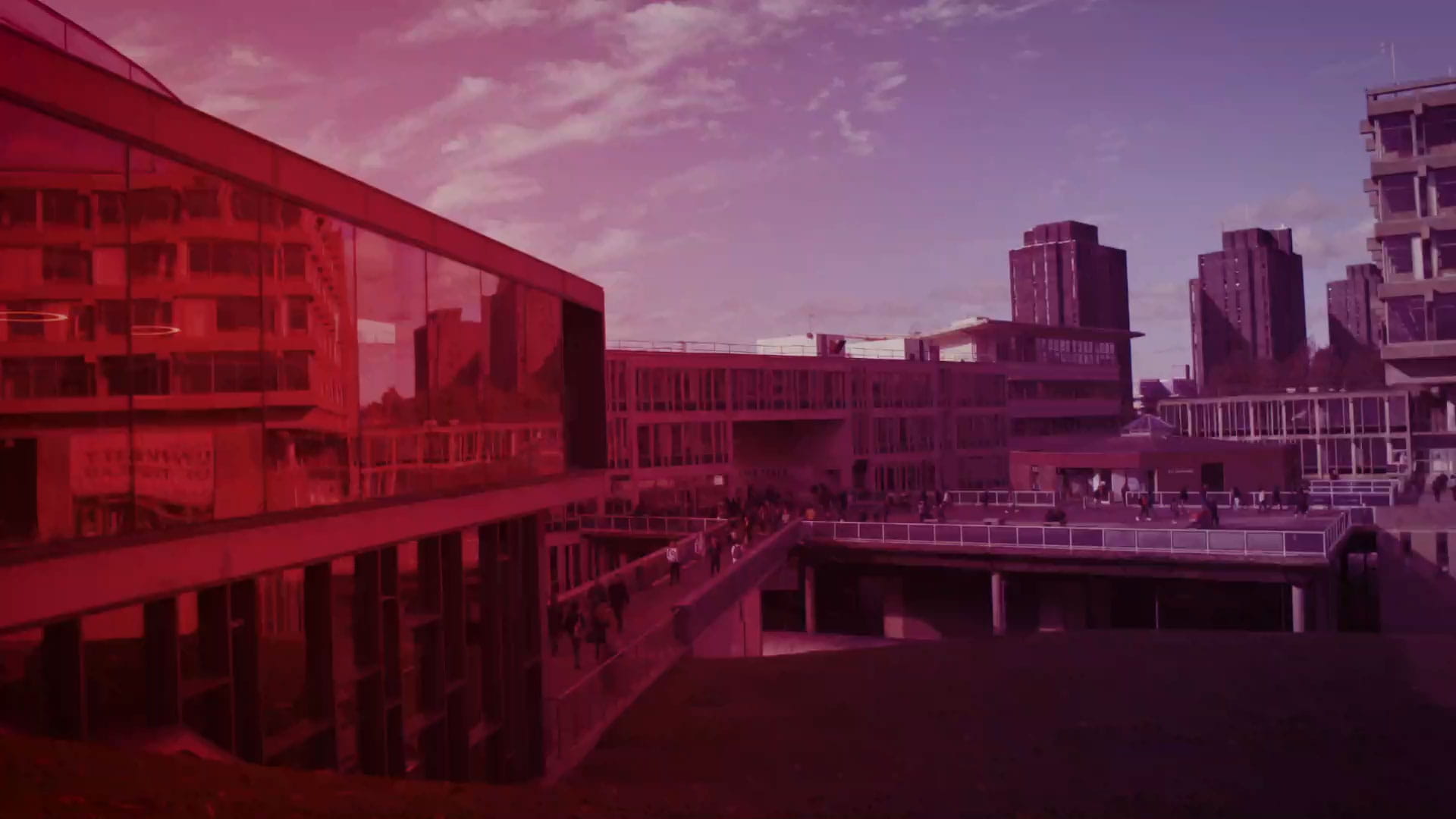 View of the Silberrad Student Centre from across the lake. Image has been heavily saturated with red and purple for artistic effect.