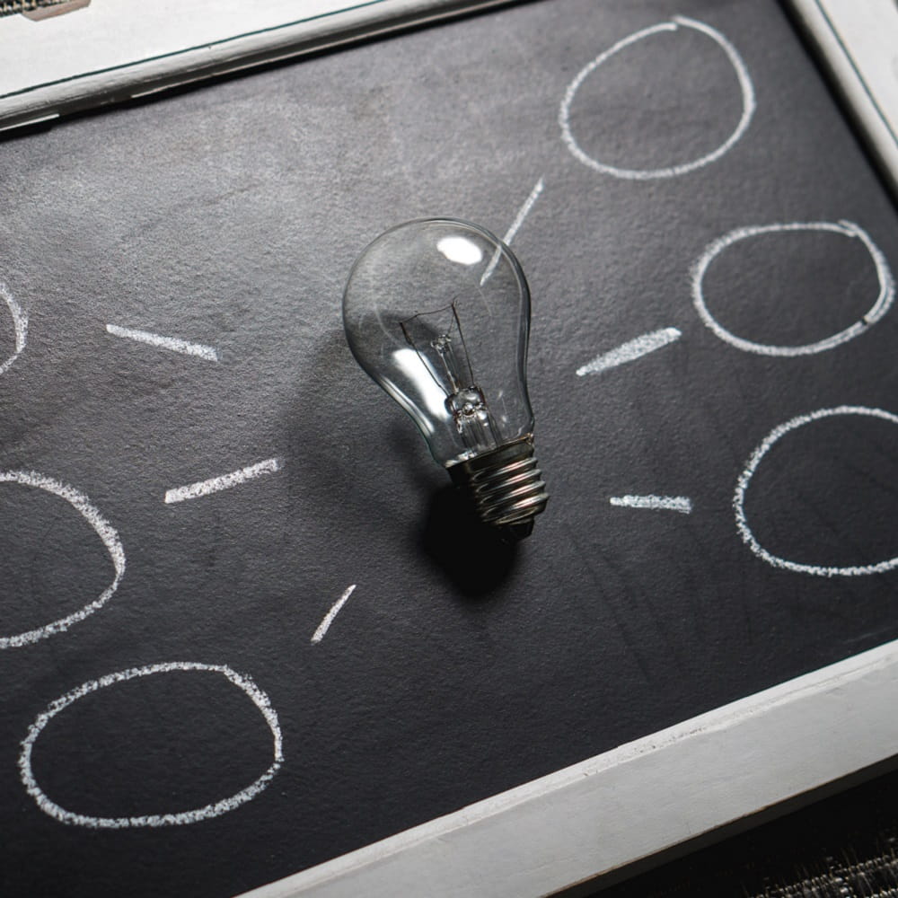 Digtial Humanities image of a lightbulb on blackboard
