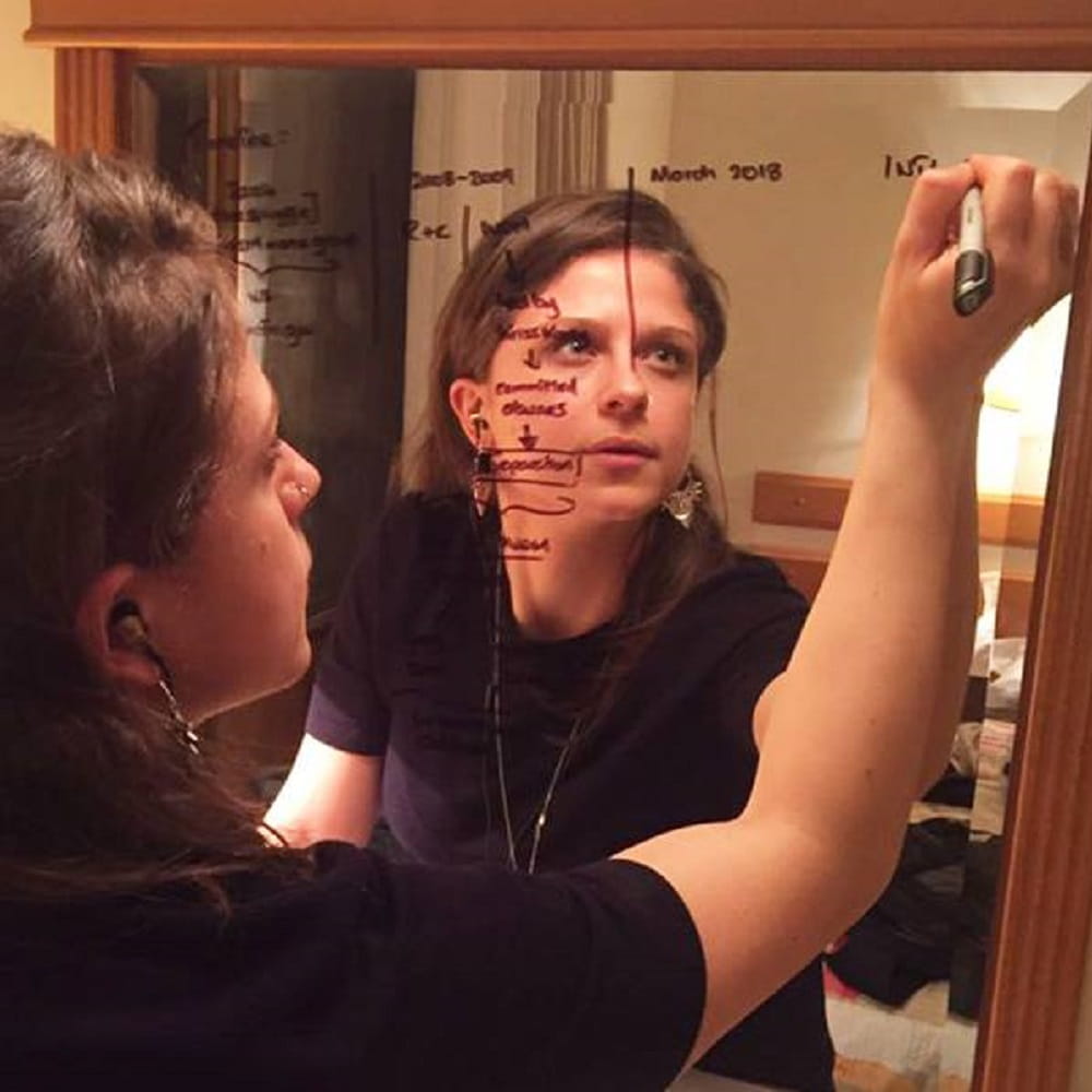Student drawing on a mirror