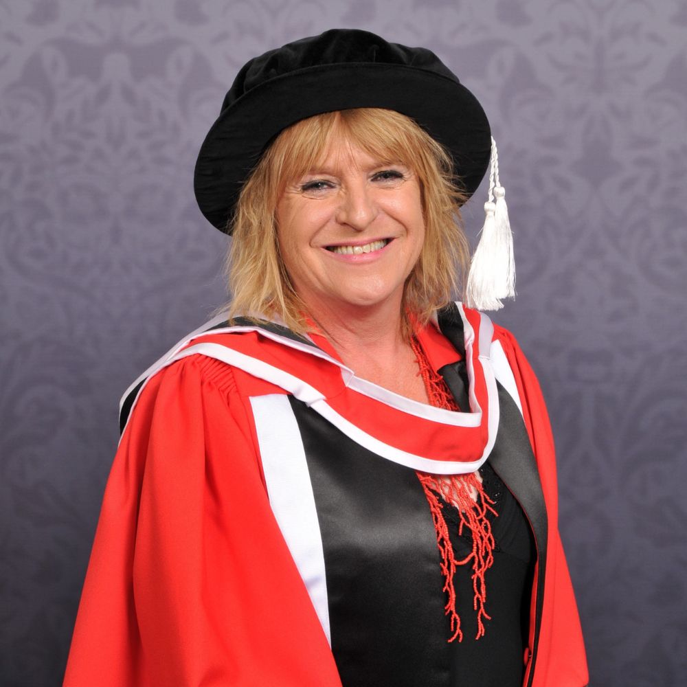 Deborah wears a ceremonial gown and cap.