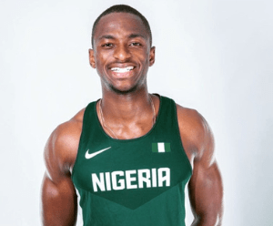 Adeseye in front of a white background in a green Nigeria running vest