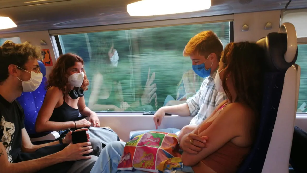 4 students wearing masks on a train