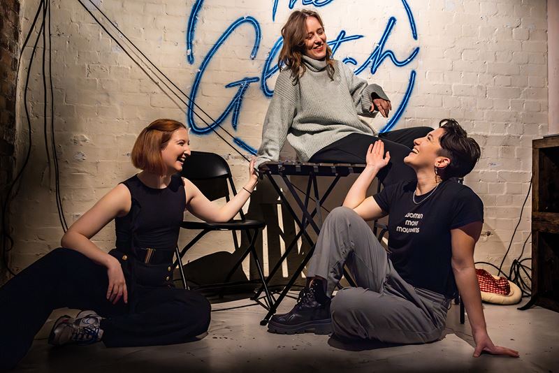 Marina Cusi Sanchez and her cast sit on the floor of the stage at The Glitch in rehearsals for the play Witchunt.