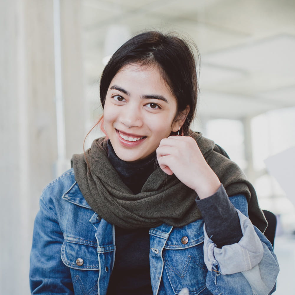 This is a photo of a female psychology student smiling and looking at the camera.