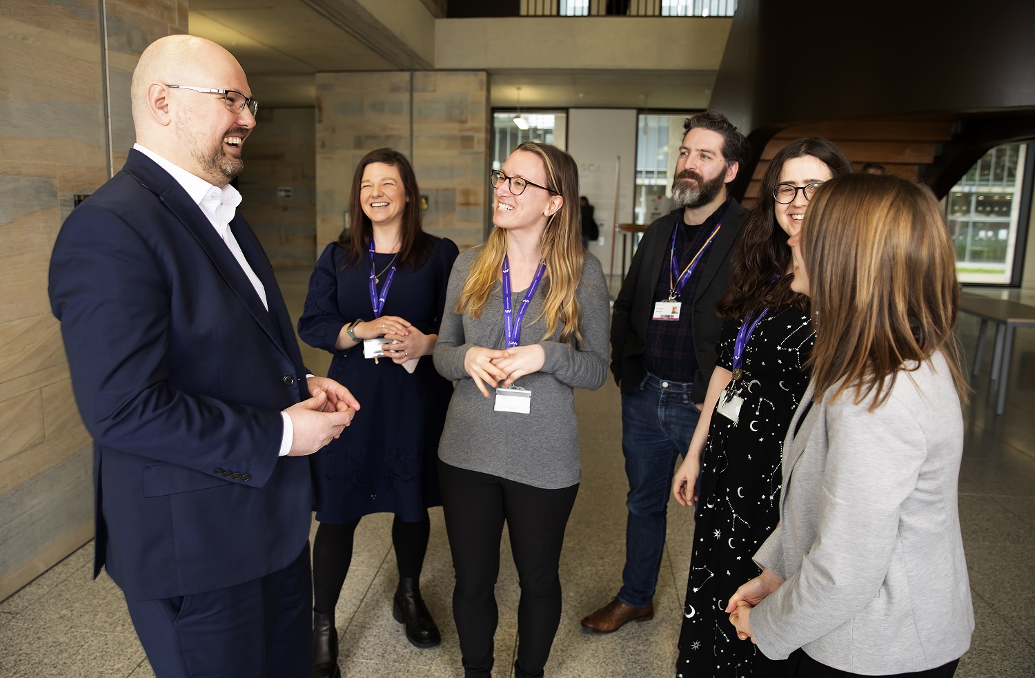 Jonathan White, Director of Library and Cultural Services and University of Essex Librarian converses with four female and one male colleagues in the Silberrad Student Centre.