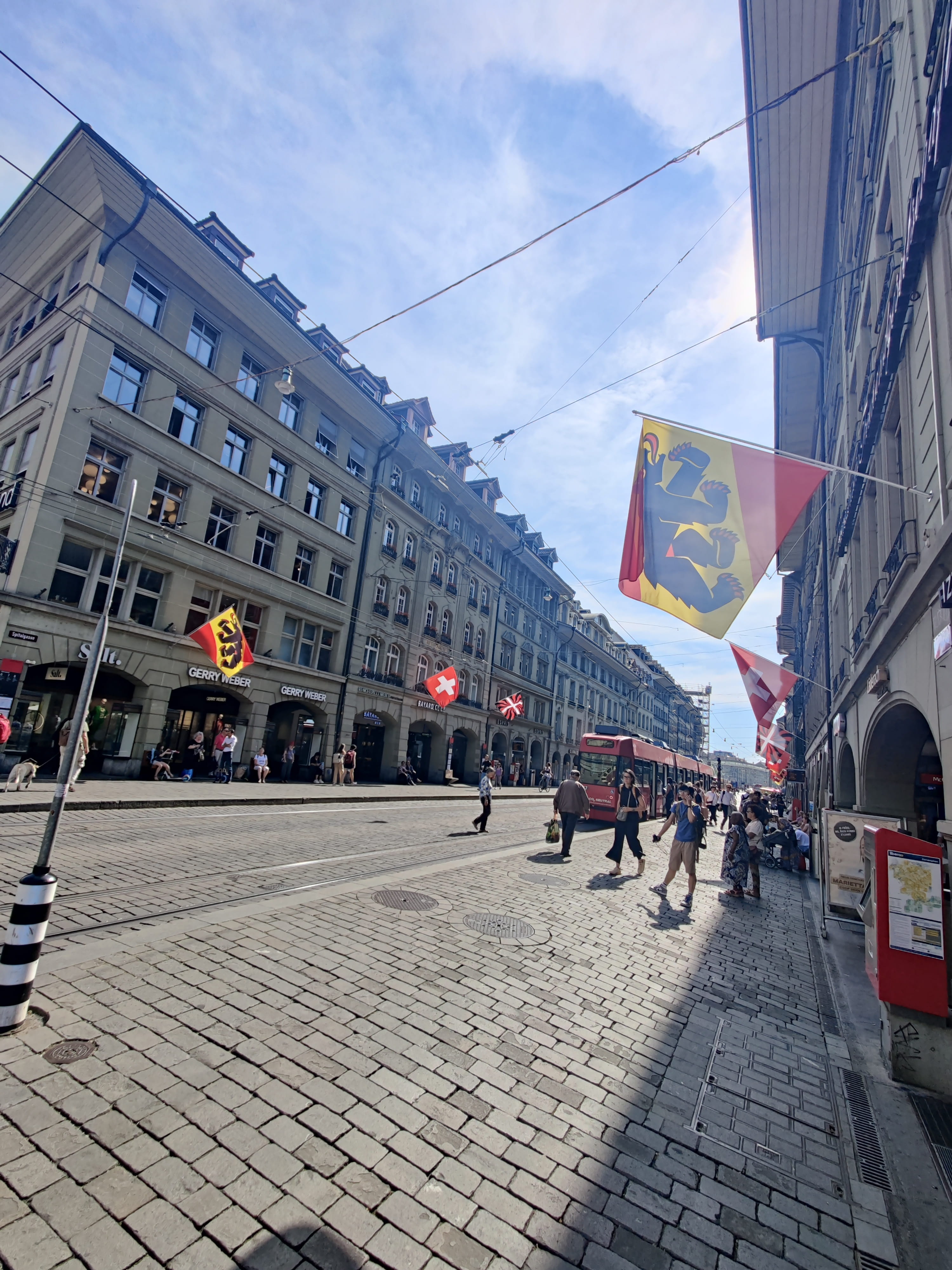 street in Switzerland lined with buildings and flags