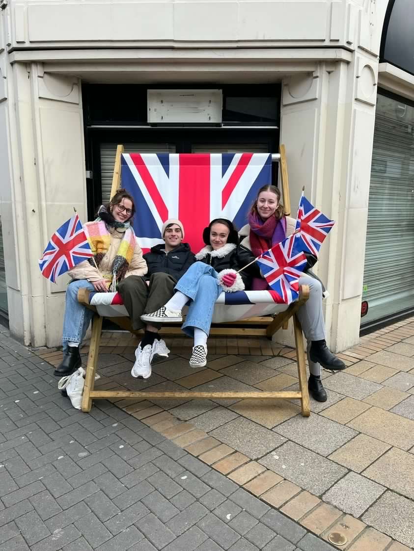 students sitting in giant deckchair decorated with Union Jack