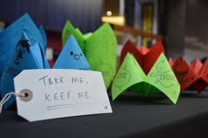 Paper fortune tellers with sign telling people to "Take me, keep me"