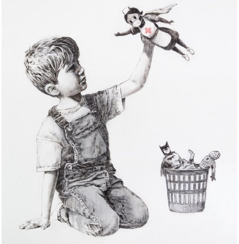 Banksy artwork showing a young boy kneeling by a small bin dressed in dungarees.