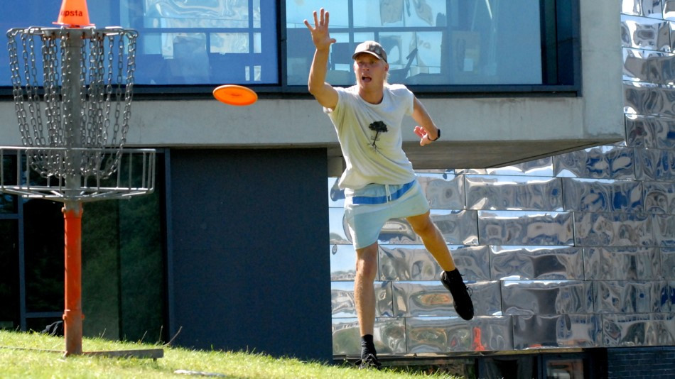 Danish player Jens Bak at the 2012 European championships playing a disc golf hole next to the Ivor Crewe Lecture Hall