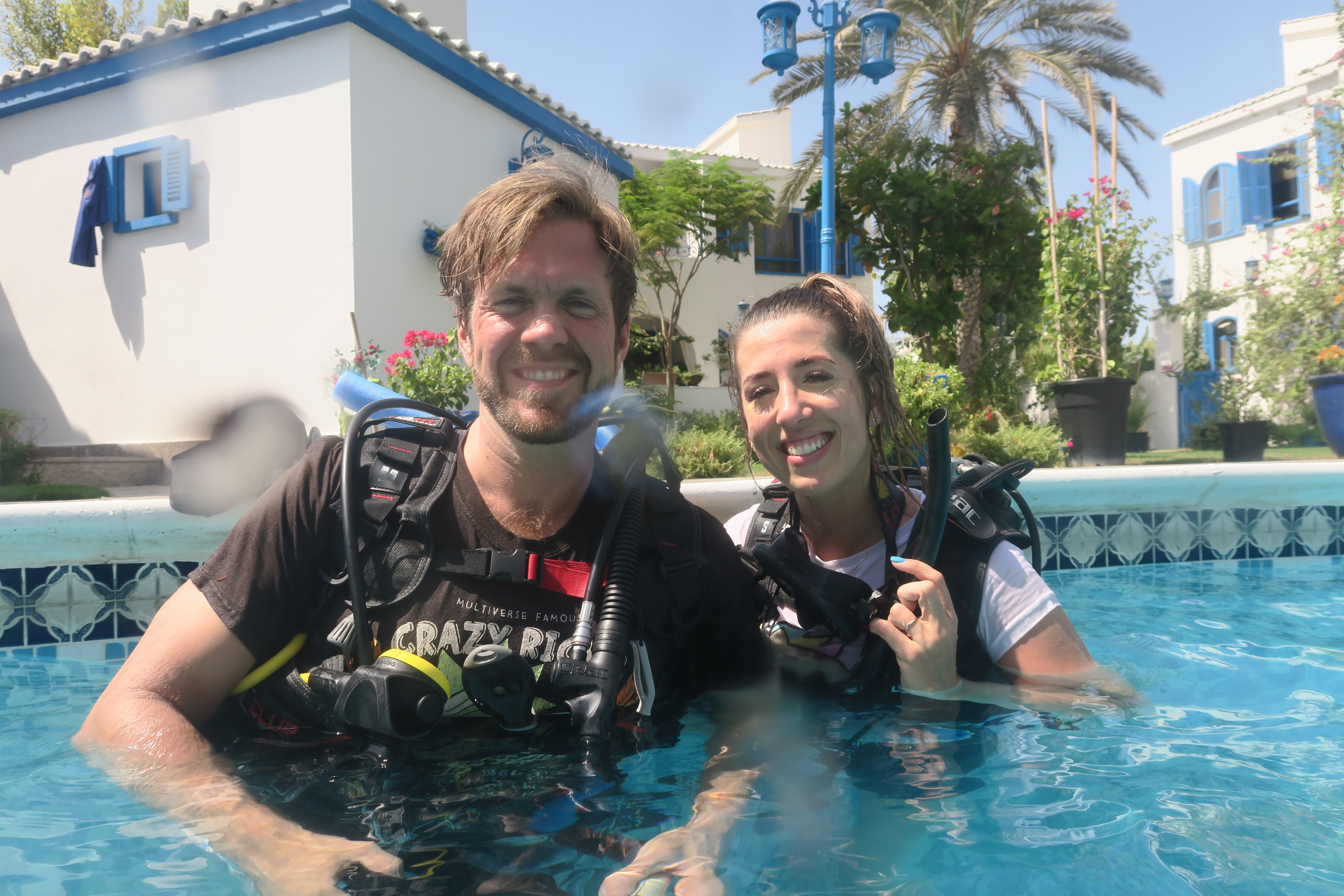 Amie and her partner scuba diving in a pool.