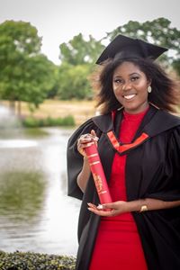 Study abroad student, Fiona in their graduation gown with their certificate