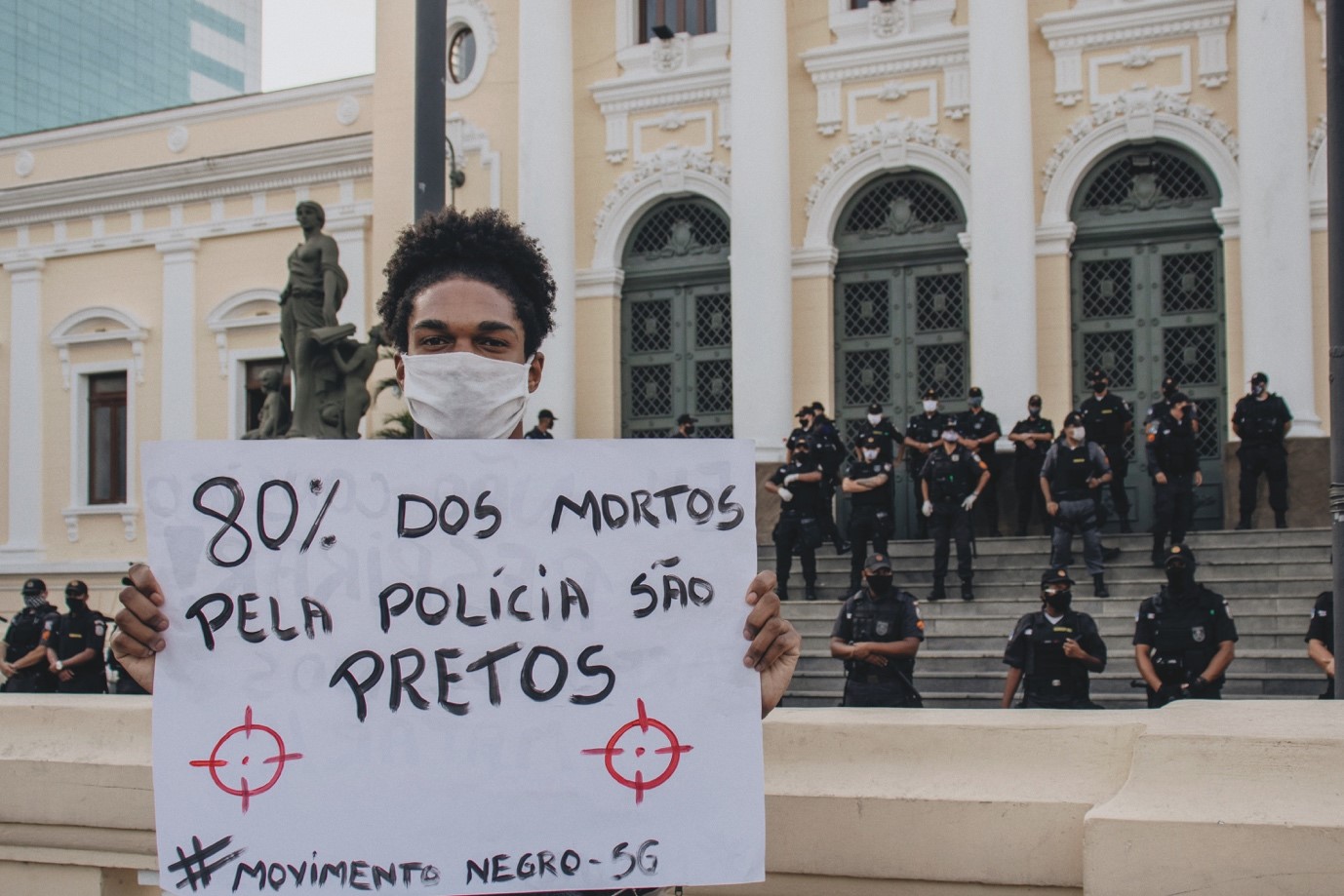 placard reading in Portuguese: 80% dos mortgos pela policia sao pretos