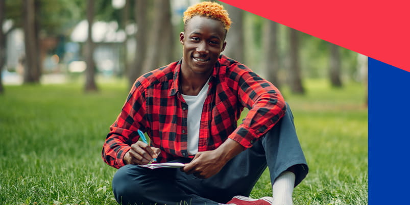 YUFE student sitting on the grass