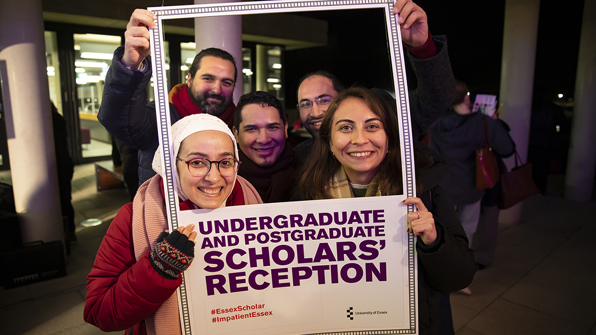 Students posing in Polaroid-style frame during Scholars' Reception celebrations)