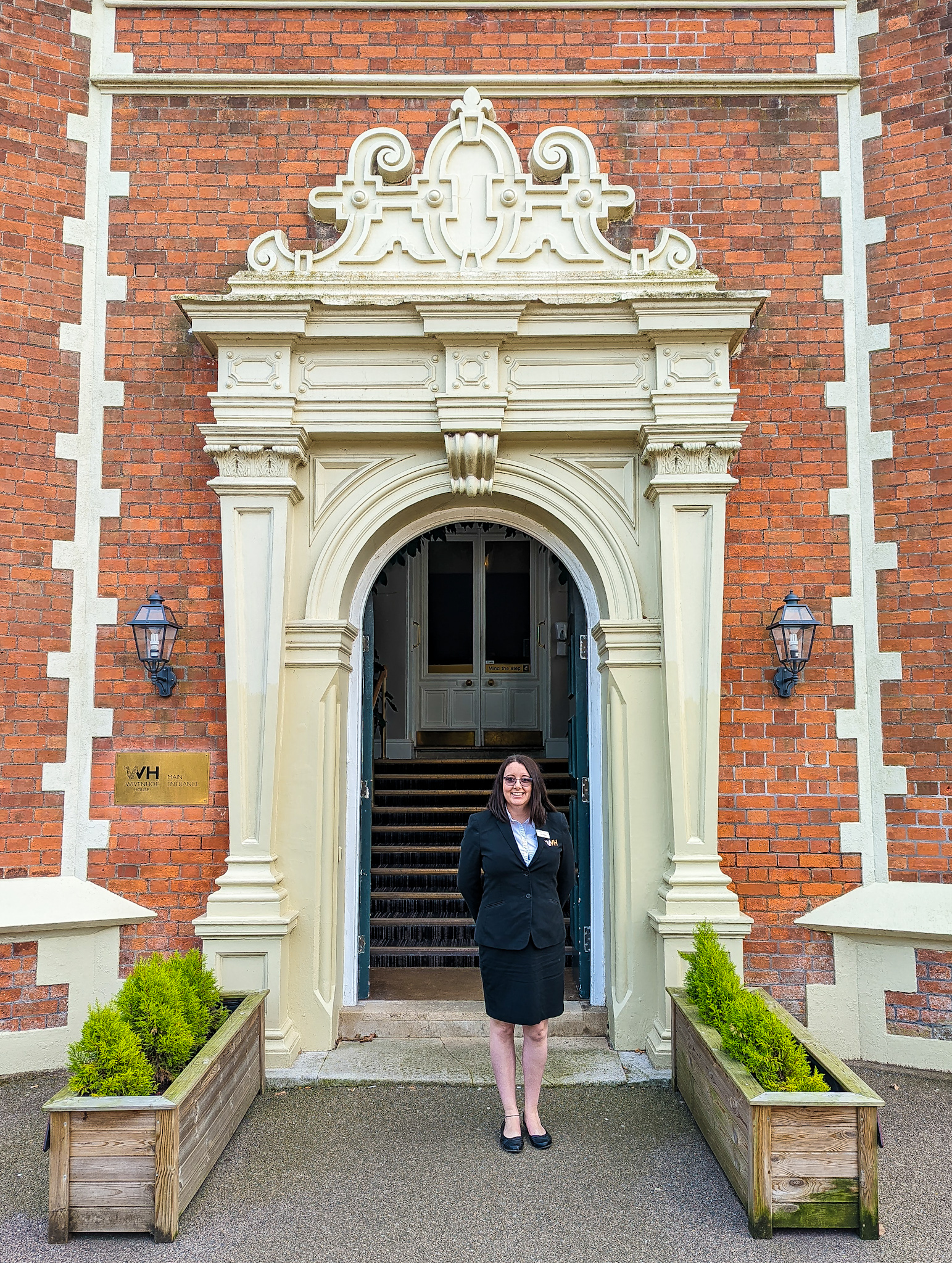 Person stood in front of Wivenhoe House Hotel