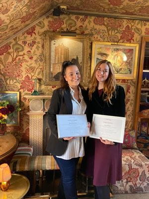 Aurora and Breeze holding their certificates in 5 Hertford Street