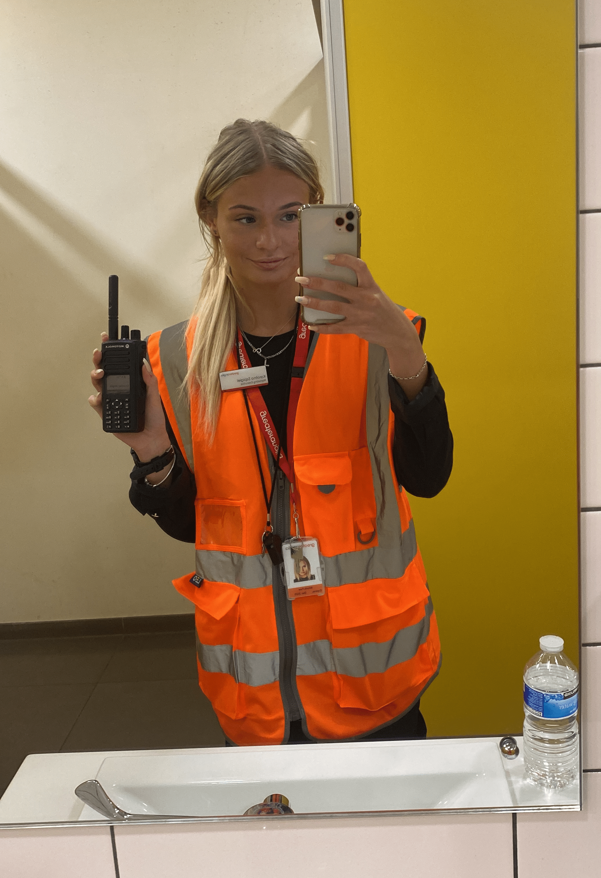 Karolina Szpigiel in a high vis tabard holding a walkie talkie