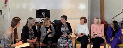 Photo of EBS International Women’s Day event Chair and Panellists in action. From left to right the Chair Dr. Anna Sarkisyan, Alumni Claire Penketh, Professor Claudia Girardone, Student Services Advisor Teresa Alvarez, Alumni Bridget Connell and Sam Honey, and Leila Thomas the CEO of Urban Synergy.