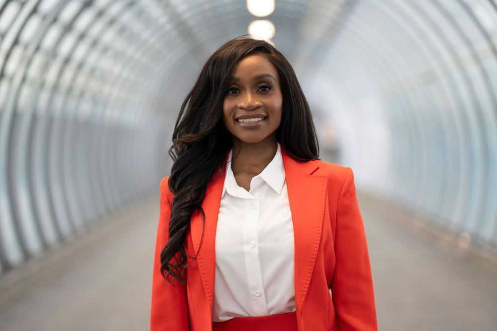 Chisola Chitambala standing in a tunnel with lights over her head.