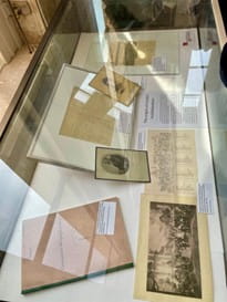 Museum display case showing letters and documents relating to global health.